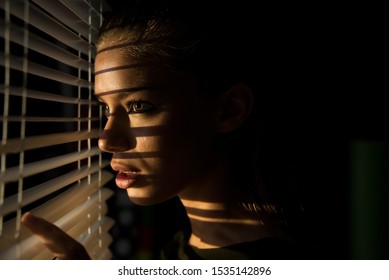 poster style Portrait of young woman looking through  sun blinds window shutter artistic version  - Powered by Shutterstock