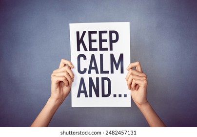 Poster, text and hands in studio with keep calm message, announcement and reminder against grey background. Mockup, word and letter banner with relax quote, inspiration and card, person or ad paper