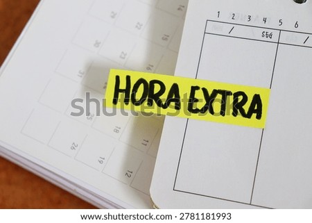 Post-it note with the words "Hora Extra" (Overtime, in Portuguese) on a personal planner. Concept of working extra hours, professional workload, and labor management. 