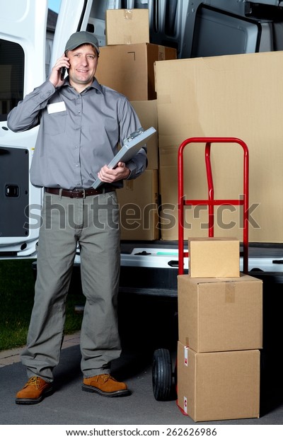 Postman with\
parcel box. Postal delivery\
service.