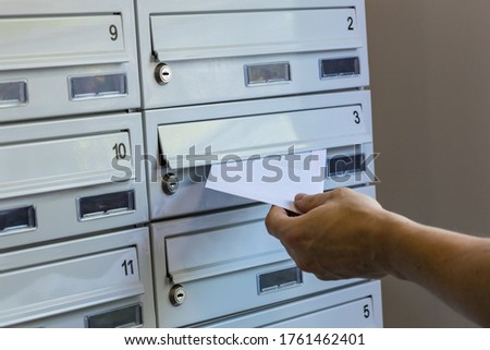 A postman throwing packages into mailboxes