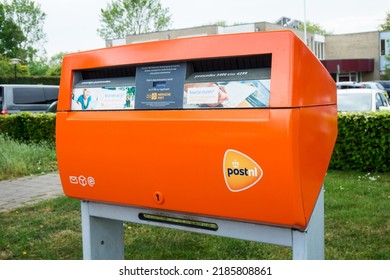 PostNL Orange Mail Box With Logo. Dutch Postal Service Company Letterbox. Hertogenbosch, The Netherlands - May 7, 2022.