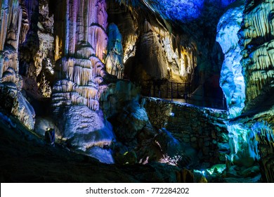Postojna cave, Slovenia. Formations inside cave with stalactites and stalagmites. Low light image.