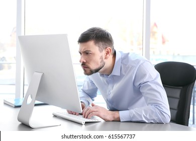 Posture concept. Man working with computer at office - Shutterstock ID 615567737