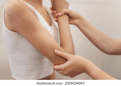 posture correction. Chiropractic, back pain relief. Professional female physical therapist doing shoulder, elbow and hand massage in hospital elbow - Powered by Shutterstock