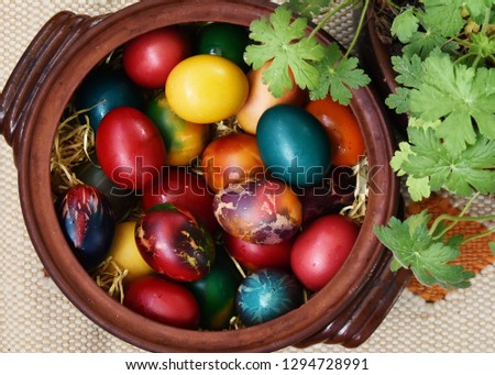 Pot full of multicoloured Easter eggs. Bulgarian tradition. Close-up selective focus view. 