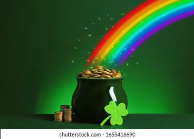 Pot with gold coins and clover on table against dark background. St. Patrick's Day