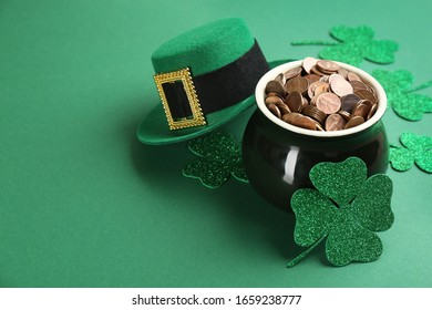 Pot of gold coins, hat and clover leaves on green background, space for text. St. Patrick's Day celebration - Powered by Shutterstock