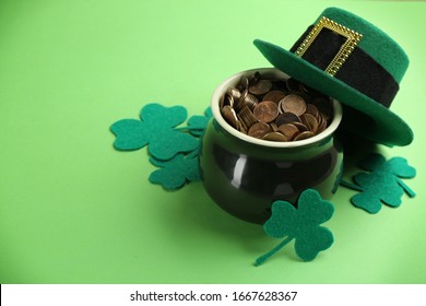 Pot Of Gold Coins, Hat And Clover Leaves On Green Background, Space For Text. St. Patrick's Day Celebration