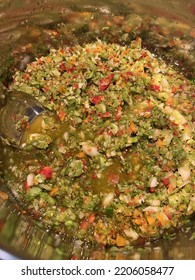 A Pot With A Metal Spoon In The Making Of A Relish Containing Chopped Peppers, Onion, Green Tomatoes And Spices