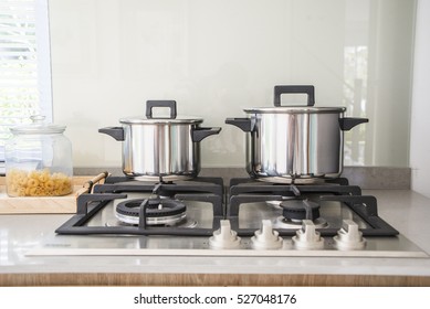 Pot On The Gas Stove And Cooking In  Kitchen 