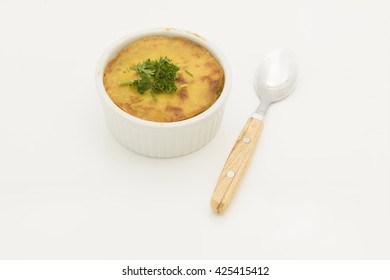 Pot Pie With Crispy Mashed Potato Top And Parsley Garnish. Potato Pie In Shallow Casserole Dish And Spoon By The Side.  Isolated On White Background.