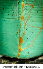 A Pot Repaired With The Japanese Art Form Of Kintsugi Using Urushi Lacquer And Gold Powder.  Shot With A Shallow DOF.