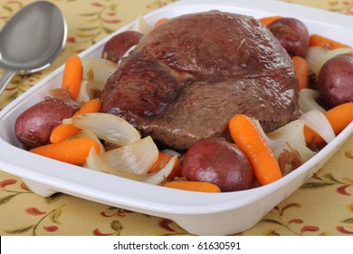 Pot Roast With Carrots, Onions And Potatoes In A Serving Plate