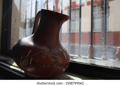 A Pot side to the window with lighting going through.