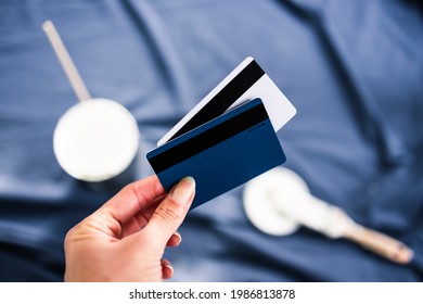 Pot Of White Paint With Paint Tray Roller And Brushes With Payment Card On Top Of Blue Drop Sheet Concept Of Costs Of DIY And Renovating, Shot At Shallow Depth Of Field With Paint Can Text Blurred