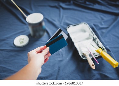 Pot Of White Paint With Paint Tray Roller And Brushes With Payment Card On Top Of Blue Drop Sheet Concept Of Costs Of DIY And Renovating, Shot At Shallow Depth Of Field With Paint Can Text Blurred