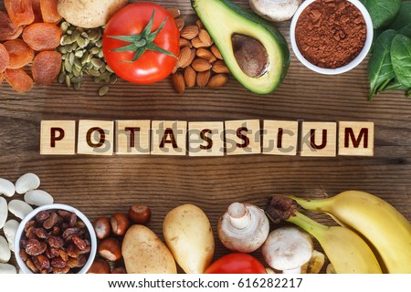 Potassium Food Sources as dried apricots, raisins, avocado, cocoa, bean, pumpkin seeds,, potatoes, tomatoes, spinach, mushrooms, fresh banana, hazelnuts, almonds. Stock foto © 