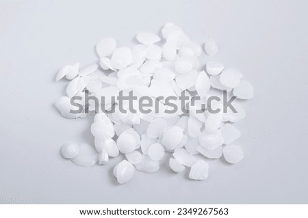 Potassium hydroxide or caustic potash on light grey background.