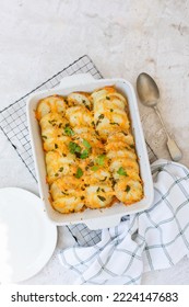 Potato Bake With Cheese On A Wire Cooling Tray In An Oven Dish. Overhead View Or Top Shot.