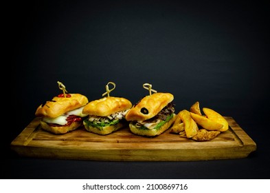 Potato Bun Filled With Freshly Ground Beef Patty, Relish Salad, Rocca Leaves, Cheddar Cheese And Chimichurri Sauce