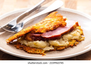 potato cakes with smoked meat and sour cabbage