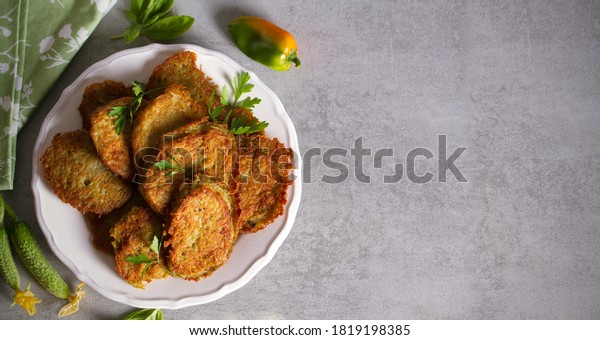 Potato cakes. Vegetable fritters, pancakes, latkes\
- dish consisting of pan fried shredded potatoes. View from above,\
top view, copy space