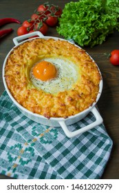 Potato Casserole With Bolognese. Baked Potato Casserole With Egg And Grated Cheese In A Ceramic Oval Baking Sheet. Wooden Dark Background. View From Above.