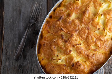 Potato Casserole With Ground Beef And Vegetable Filling In A Rustic Baking Pan Isolated On Wooden Table Background. 