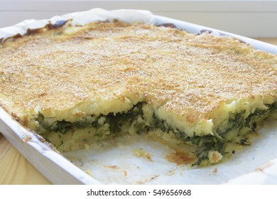 Potato Casserole With Spinach On A Pan.