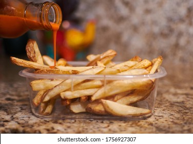 Potato Chips Air Fryed Served In Plastic Box And Adding Hot Sauce.