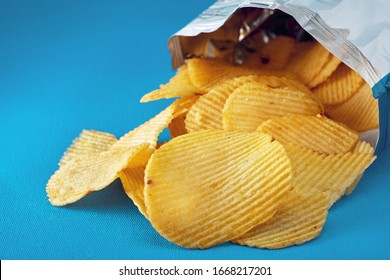 Potato Chips In A Bag Or Package Spill Out On The Table. Macro Close Up View. 