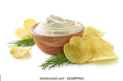 potato chips and bowl of sour cream dip isolated on white background