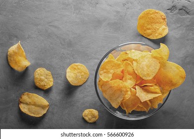 Potato chips in bowl with tomato juice in glass