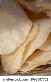 Potato Chips In A Bundle Close Up. Crispy Potato Chips To Eat From Bag As Snack With Calories And Cholesterol Crisp Closeup.