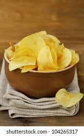 potato chips in ceramic bowl on a wooden table