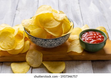 Potato chips or crisps, popular salty snack served in bowl
