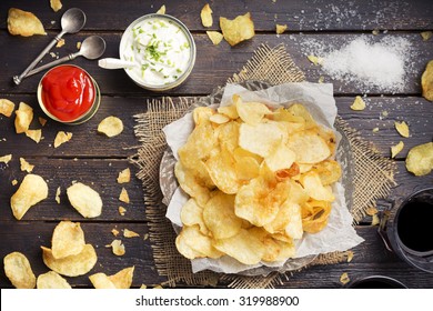 Potato chips with dipping sauces on a rustic table. Photographed from directly above. - Powered by Shutterstock