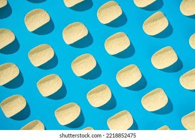 Potato Chips Infinite Pattern On A Light Blue Background. Flat Lay, Top View. Snack Food Pattern.