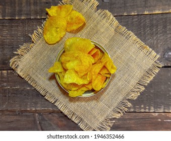 Potato Chips With Ketchup on wood Background