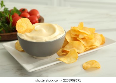 Potato Chips And Mayonnaise On White Marble Table