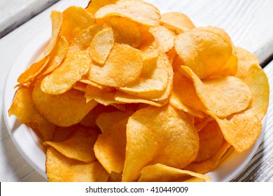 Potato Chips On A Plate. White Plate With Yellow Chips. Fast Snack At New Diner. Good Example Of Processed Food.