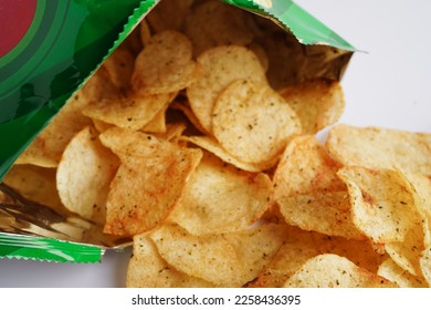 Potato chips in open bag, delicious BBQ seasoning spicy for crips, thin slice deep fried snack fast food in open bag. - Shutterstock ID 2258436395