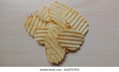 Potato Chips With Original Flavor And Color On A Wooden Surface.