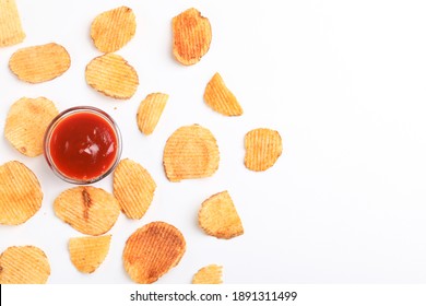 Potato chips with tomato ketchup isolated on white background - Shutterstock ID 1891311499