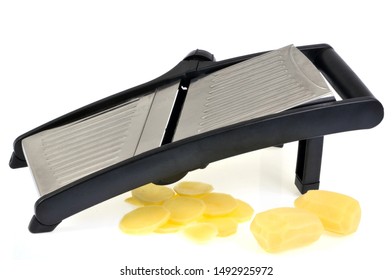 Potato Cut With A Kitchen Mandolin In Closeup On White Background