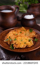 Potato fritters (a pancake, especially one made with grated potato) served with sour cream, herbs and a jug of milk. Country style.