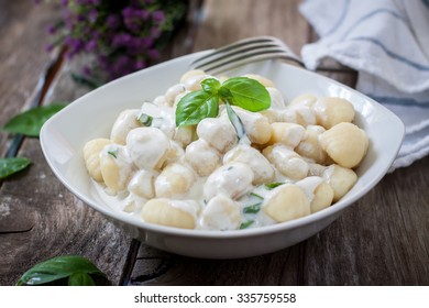 potato gnocchi pasta with cheese sauce and basil - Powered by Shutterstock