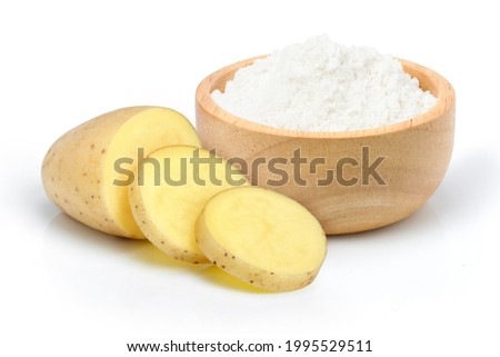 Potato ground in wooden bowl and raw potatoes with slices isolated on white background. 