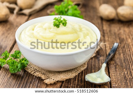 Potato Mash on rustic wooden background (close-up shot)
